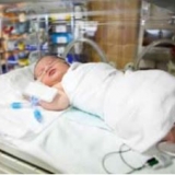 Baby laying in an incubator