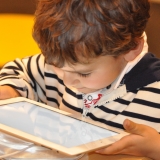 child reading from a tablet