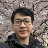 Jianhao in front of a cherry blossom tree